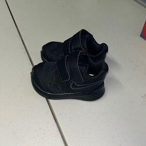 Black nike baby sneakers go fast